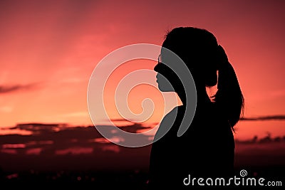 Silhouette of lady and twilight. Stock Photo