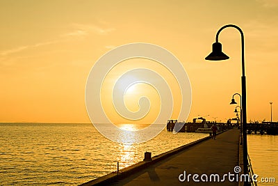 Silhouette lamp pole on the long bridge in evening with skylight after sunset Stock Photo