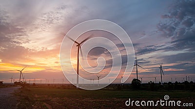 Silhouette large wind turbines at sunrise taken from the air. Stock Photo