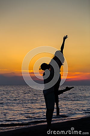 Silhouette of Lovely Couple at the beach Stock Photo