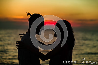 Silhouette of Lovely Couple at the beach Stock Photo