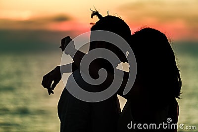 Silhouette of Lovely Couple at the beach Stock Photo