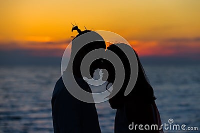 Silhouette of Lovely Couple at the beach Stock Photo