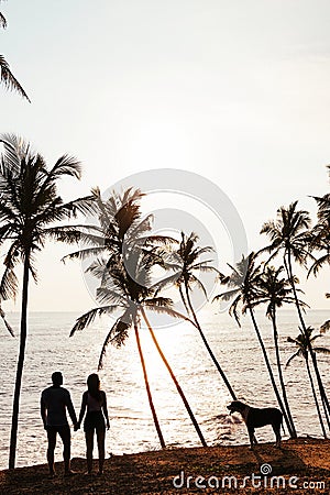 Silhouette of loving couple on sea. A couple in love at sunset. Man and woman meet sunset. Happy loving couple. Silhouette lovers Stock Photo