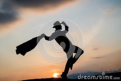 silhouette of male dancer dance in sense of freedom on sunrise sky, inspiration Stock Photo