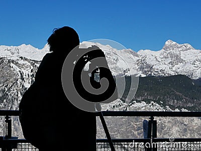 Silhouette of male landscape photographer capturing breathtaking Stock Photo