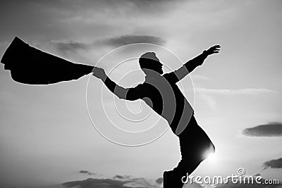 silhouette of man dancing in sense of freedom on sunrise sky, free Stock Photo