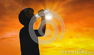 Silhouette man is drinking water bottle on hot weather background with summer season. High temperature and heat wave concept Stock Photo