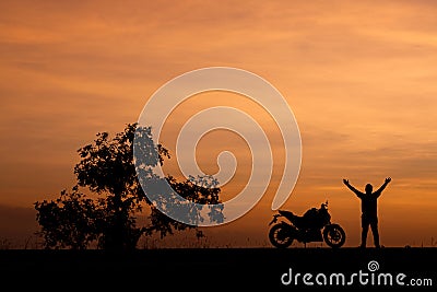 Silhouette man and his motorcycle To live a lifestyle. Stock Photo