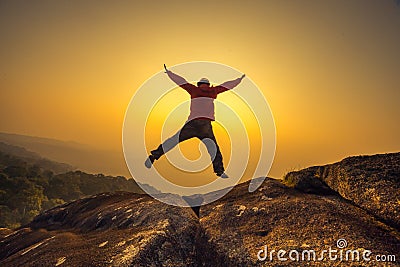 Silhouette man jumping into sunset sky Stock Photo