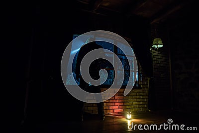 Silhouette of a man looking a dreamlike galaxy through a window Stock Photo