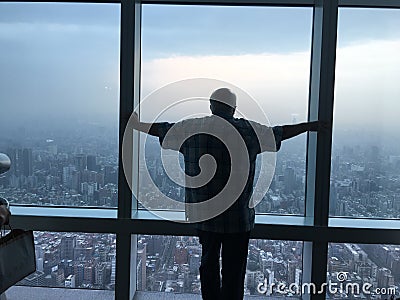 Silhouette of man looking out over Taipei skyline Editorial Stock Photo