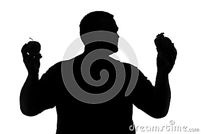 Silhouette of a man with obesity choosing between healthy and un Stock Photo