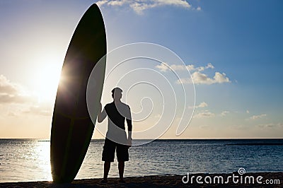 Silhouette of a man with paddle board Stock Photo