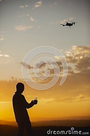 Man piloting a drone during the sunrise Stock Photo