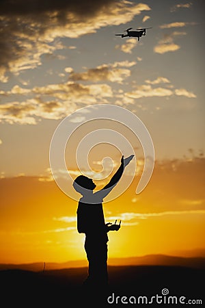 Man piloting a drone during the sunrise Stock Photo