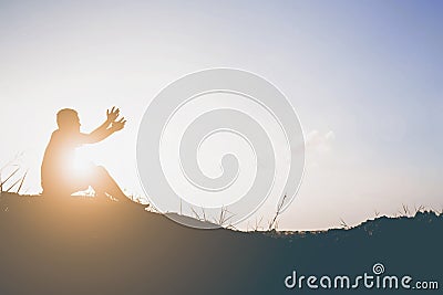 Silhouette of man pray there is hope. Stock Photo