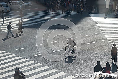Silhouette of man ride the bicycle across street Editorial Stock Photo