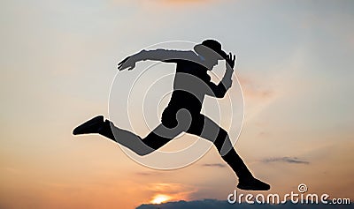 silhouette of man running in sense of freedom on sunrise sky, stamina Stock Photo