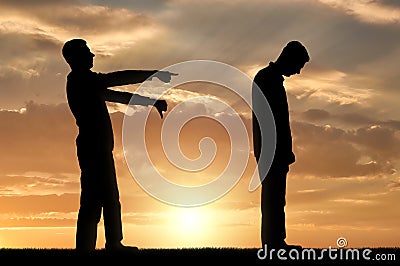 A silhouette of a man showing a finger at another man telling him that he is a loser Stock Photo