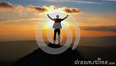 silhouette of a man on top who has reached the top of the mountain Stock Photo