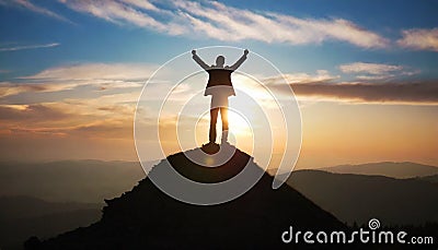 silhouette of a man on top who has reached the top of the mountain Stock Photo