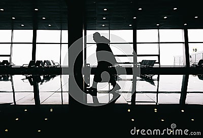 Silhouette of man walking in modern building Stock Photo