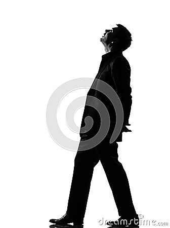 Silhouette man walking musing looking up Stock Photo