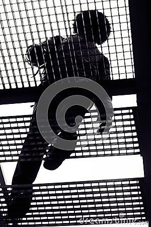 Silhouette man walking stairs. Black and white image. Bottom view Stock Photo