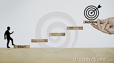 Silhouette man walking on wooden stairs step from start to achieve with objective target on hand Stock Photo