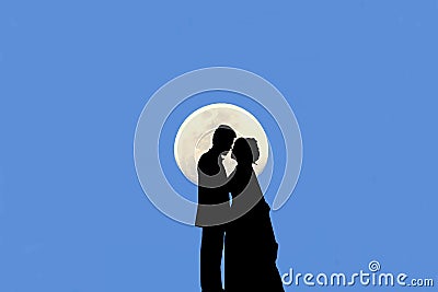 Silhouette of married couple kissing There is a moon and the bl Stock Photo