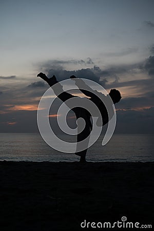 Silhouette of martial arts man training taekwondo Stock Photo