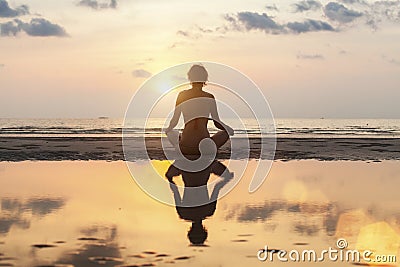 Silhouette meditation girl on the background of the stunning sea and sunset Stock Photo