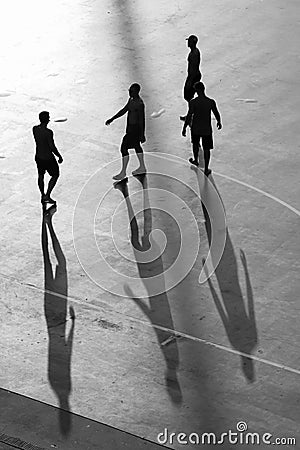 Silhouette of men player on playground at sunset Stock Photo