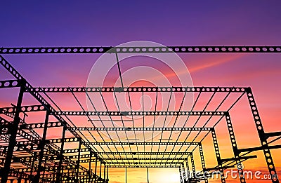 Silhouette of castellated beam of factory building structure in construction site against colorful sunset sky background Stock Photo