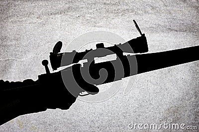 Silhouette of a military carbine on a stone background. Arms in the male hand. Shotgun for long range shooting Stock Photo