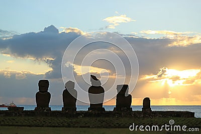 Silhouette of the Moais at Ahu Tahai Ceremonial Platform against Sunset over Pacific Ocean, Easter Island Stock Photo