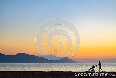 Silhouette of mother with baby stroller enjoying motherhood at s Stock Photo