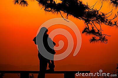 Silhouette mother and Child lovers natural background at the beach and mountain Stock Photo