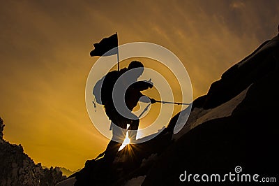 Silhouette of mountaineer and sunset. Stock Photo