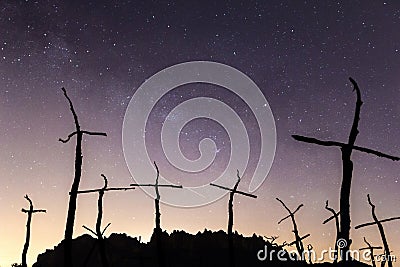 Silhouette of mountains and crosses with the Milky Way on the background Stock Photo