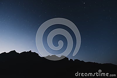 Silhouette mountains ridge, with clear sky full of star in dawn Stock Photo
