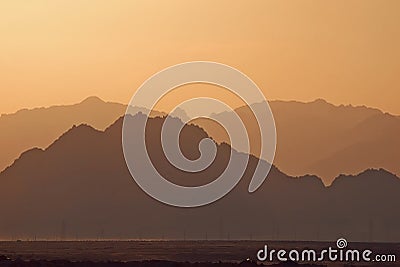 Silhouette of mountains at sunset in the evening at dusk Stock Photo