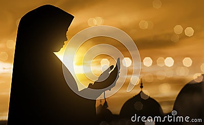 Silhouette of muslim woman praying with prayer beads Stock Photo