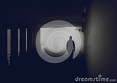 Silhouette of mysterious man in misty tunnel. Stock Photo