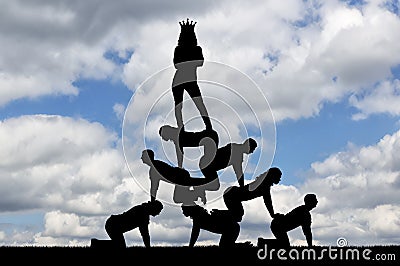 Silhouette narcissistic egoist woman with a crown on his head standing on humans Stock Photo