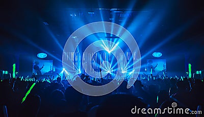 Silhouette in night club under blue light rays beam Stock Photo