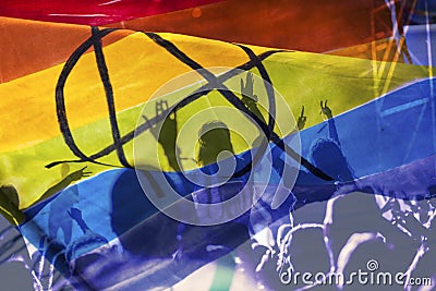 silhouette of a parade of gays and lesbians with a rainbow flag - symbol of love and tolerance Stock Photo