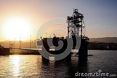 Silhouette of an offshore drilling rig Editorial Stock Photo