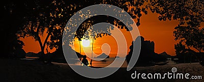 Silhouette of Panoramic landscape of Ang Thong archipelago island in Thailand with a girl sitting on a swing or cradle on the Stock Photo